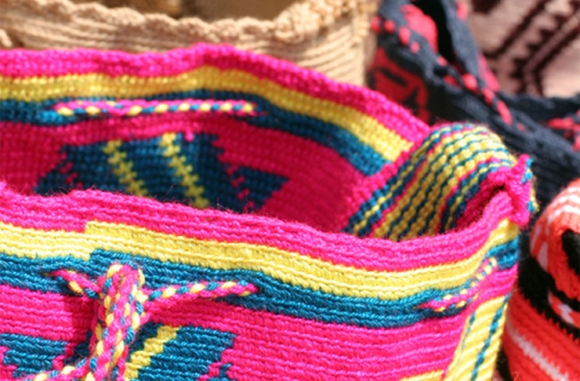 No two bags are exactly alike. Wayuu mochilas, like the ones seen here, tell the stories of the tribes people as well as relay legends and myths through the vibrant, colorful shapes and designs.