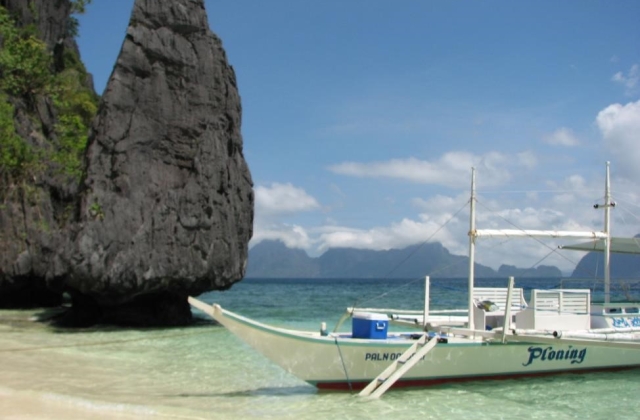 Traveling like the locals is a great way to help reduce your footprint. Pictured here is a small outrigger boat common throughout the Philippines. 