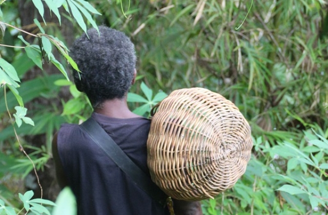 Batak man with a traditional woven basket