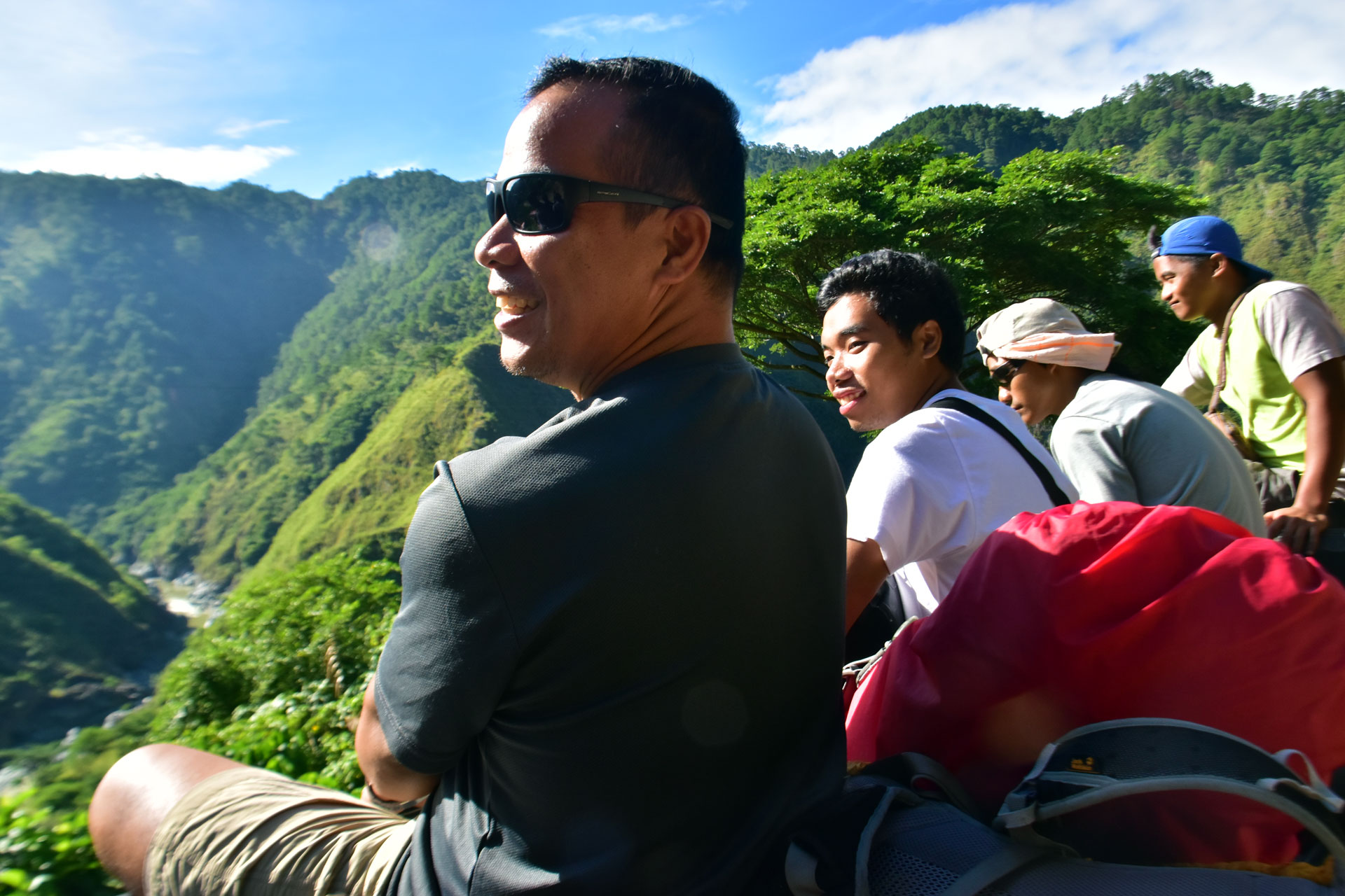 No better way to enjoy the mountain scenery than riding on the roof of a moving vehicle